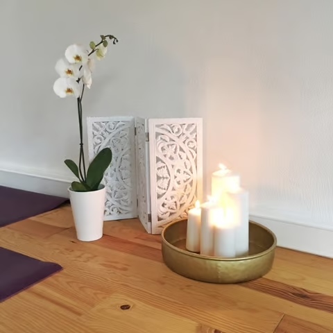 Meditationsdeko mit Kerzen und Orchidee